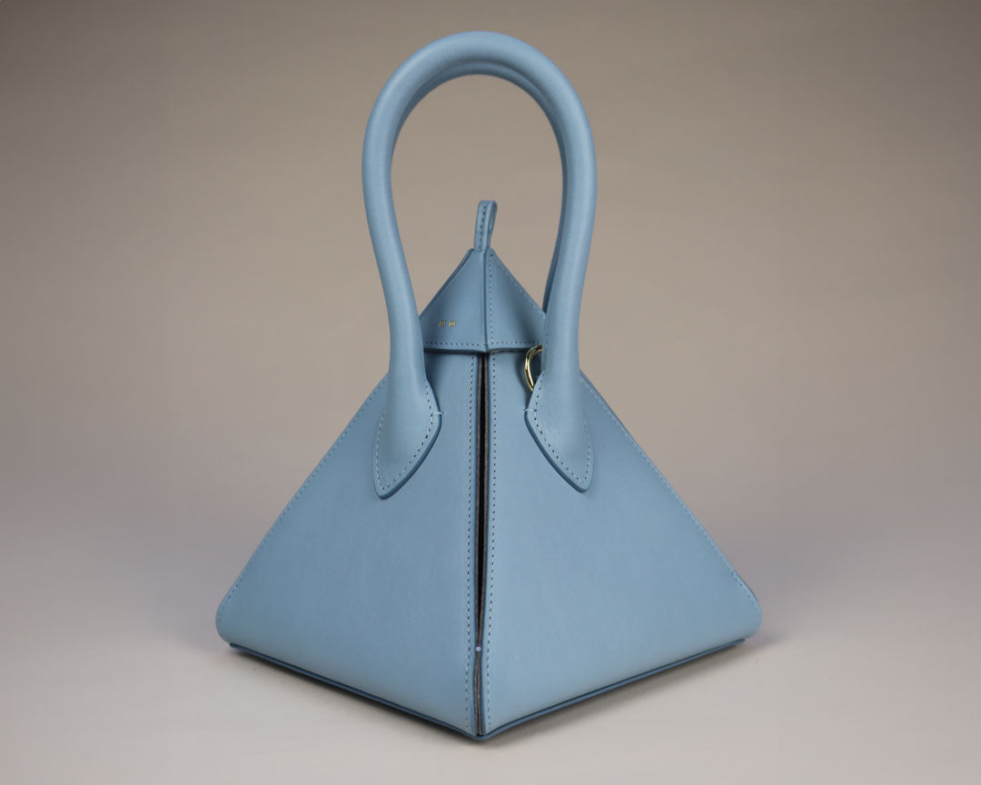 powder blue pyramid shaped leather bag